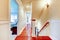 Large bright hallway with cherry hardwood and staircase.