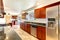 Large bright kitchen with dark cherry cabinets.