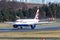 Large British Airways plane taking flight from an airport flight strip