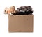 Large brown cardboard box filled with things and children`s toys,  concept of moving