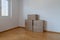 Large brown moving and packing boxes in an empty room
