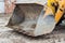 Large bucket of yellow tractor forklift, close-up, ladle