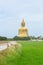 Large Buddha statue at Wat Muang in Angthong in back side rural landscape in Thailand.