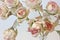 Large buds of pink and white roses. Artificial silk flowers in t