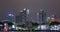 Large building illuminated by neon. Night Guangzhou, people walk through the night city