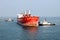 A large bulk carriers, tugboats at the port under cargo operations and underway. Close-up view of ships constructions and equipmen