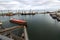 Large bulk ship entering the harbour of commercial dock at seaport to load at grain terminal elevators with wheat and