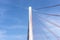 A large cable-stayed bridge on the German motorway over the river Rhine, set against a blue sky.