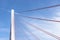 A large cable-stayed bridge on the German motorway over the river Rhine, set against a blue sky.