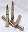 Large caliber rifle bullets on a white background