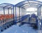Large cargo Carts for shopping for construction materials stand empty in a hangar outdoors, winter, sunlight, snow