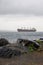 Large cargo container ship enters Bosporus strait strait of Istanbul in the stormy rainy weather