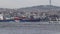 A large cargo ship loaded with containers sails the Bosphorus