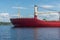 a large cargo ship on the roadstead on the river. background blue sky natural light.