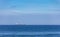 Large cargo tanker sailing across a blue sea