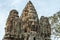 Large carved stone heads in Bayon temple in Angkor Archaeological Park, Siem Reap, Cambodia