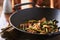 Large cast iron wok with chicken and stringbean stirfry