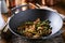 Large cast iron wok with chicken and stringbean stirfry