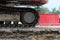 Large caterpillar of excavator on the background plastic enclosures.