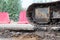 Large caterpillar of excavator on the background plastic enclosures.