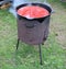 Large cauldron with delicious kharcho soup cooked on a picnic in the forest