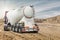 A large cement truck brought cement to the construction site. Powerful modern construction equipment. Delivery and transportation