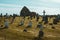 Large cemetery with gravestones on a sunny meadow