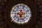 Large center stained glass window in dome surmounting Rosary Basilica at Sanctuary of Our Lady of Lourdes, silhouetted against sky