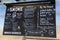 Large chalkboard sign with menu items offered at truck stand, Gulf Shores Alabama, 2018