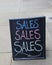 Large chalkboard with the word `Sales` written on it