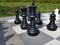 Large chess game on ground on camping site close up