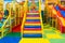 Large children`s playroom with a slide and colorful balls in entertainment center