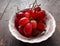 Large Chilean red grapes on top of a white dish and dark brown wooden table