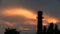 Large chimney in the background of a cloudy sunset. TimeLaps.