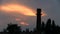 Large chimney in the background of a cloudy sunset. TimeLaps.