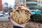 Large Chocolate Chip Cookie Held by a Hand in New York City