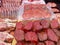 Large choice of different cuts of fresh raw red meat at farmers market