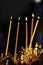 On a large Church copper candlestick lit a small candle. Orthodox Christian Church. Religion