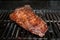 A large churrasco steak on the barbecue grill