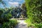 A large circular fountain with fish head sculptures in the garden surrounded by lush green trees at Huntington Library and Botanic