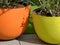 large clay flower pots in yellow and orange. abstract closeup detail.