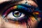 Large close-up of a female eye painted with paints and sprinkled with colored powder