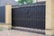 Large closed brown wrought iron gate