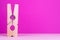 Large clothespin on pink background