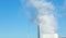 Large clouds of steam rising from a factory