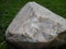 Large cobblestone in the park. Stone-embossed smooth wavy lines. Rock art