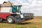 A large combine works in a wheat field