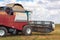 A large combine works in a wheat field