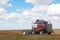 A large combine works in a wheat field