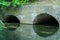 A large concrete pipe for diverting the river under the highway. Leaky dirty water from large concrete pipes. Dirty sewage from